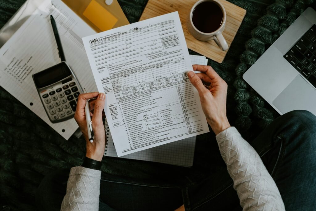 Photo by <a href="https://unsplash.com/@kellysikkema?utm_source=unsplash&utm_medium=referral&utm_content=creditCopyText">Kelly Sikkema</a> on <a href="https://unsplash.com/photos/hands-holding-tax-forms-with-calculator-and-laptop-8XrYtOYQDRU?utm_source=unsplash&utm_medium=referral&utm_content=creditCopyText">Unsplash</a>